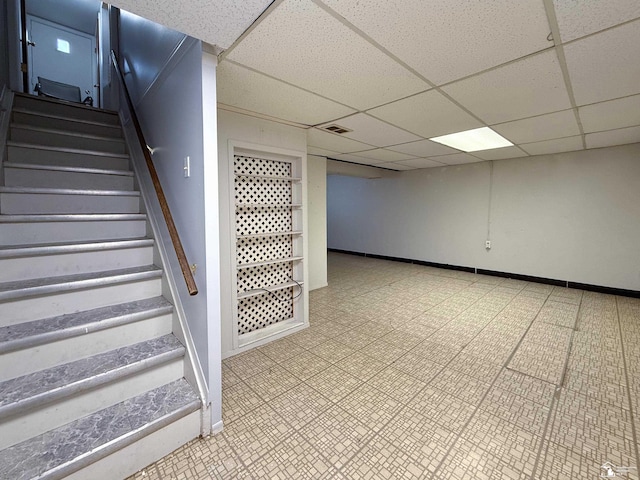 staircase with tile patterned floors, visible vents, baseboards, and a drop ceiling