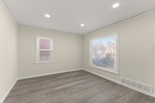 unfurnished room featuring visible vents, recessed lighting, crown molding, and wood finished floors