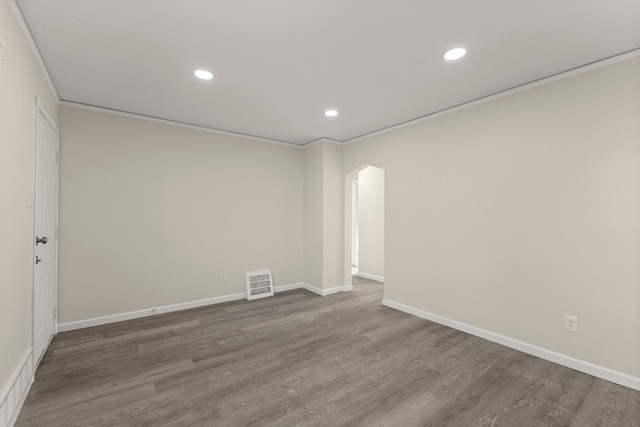 spare room with recessed lighting, visible vents, dark wood finished floors, and crown molding