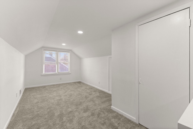 additional living space featuring recessed lighting, baseboards, lofted ceiling, and carpet floors