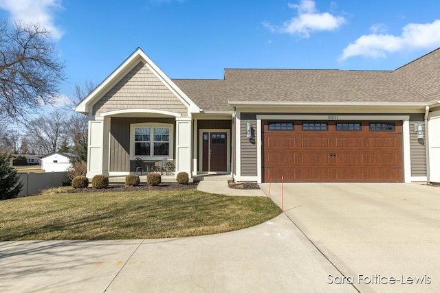 view of front facade featuring driveway, a front lawn, a porch, fence, and a garage