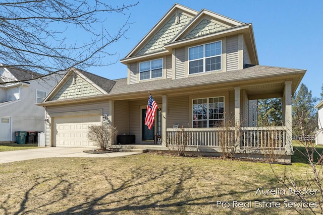 view of front of house featuring a porch, an attached garage, a front lawn, and concrete driveway