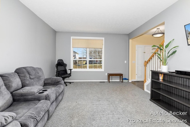 carpeted living room featuring baseboards