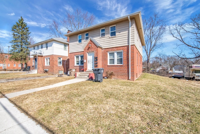 view of front of house with brick siding and a front yard