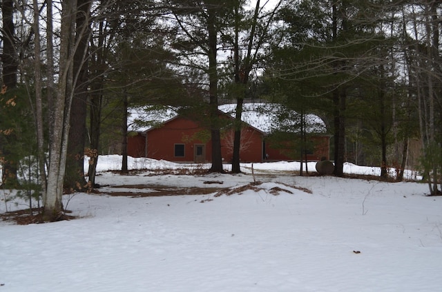 yard covered in snow with a garage