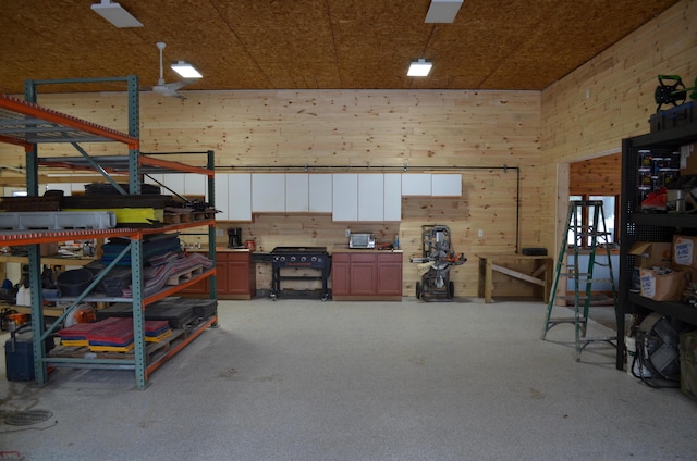 garage with a workshop area and wood walls