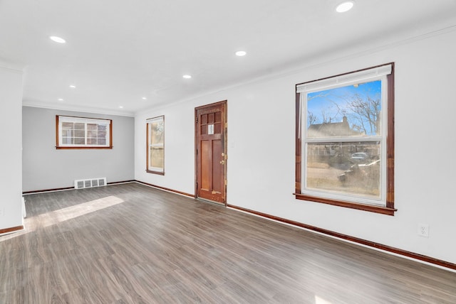 unfurnished living room featuring recessed lighting, visible vents, a healthy amount of sunlight, and wood finished floors