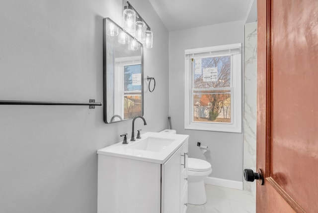 bathroom featuring marble finish floor, toilet, vanity, and baseboards