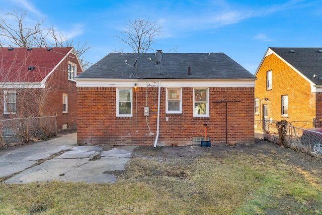 back of property featuring a yard, a fenced backyard, and brick siding