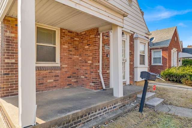 view of exterior entry with brick siding