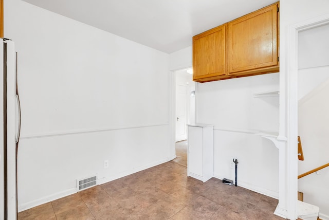 empty room featuring visible vents and baseboards