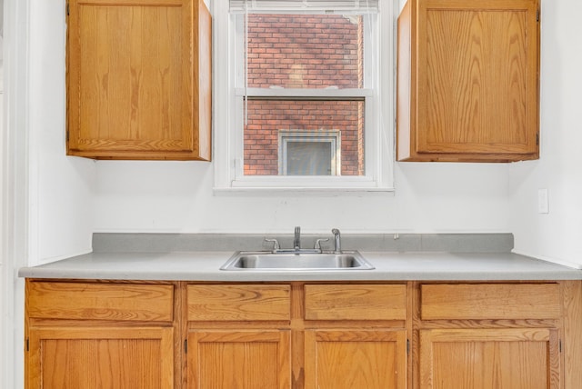 kitchen featuring light countertops and a sink