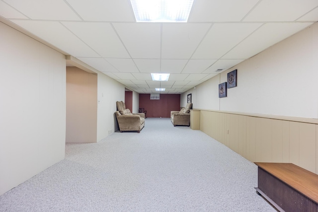 sitting room with carpet, visible vents, and a drop ceiling