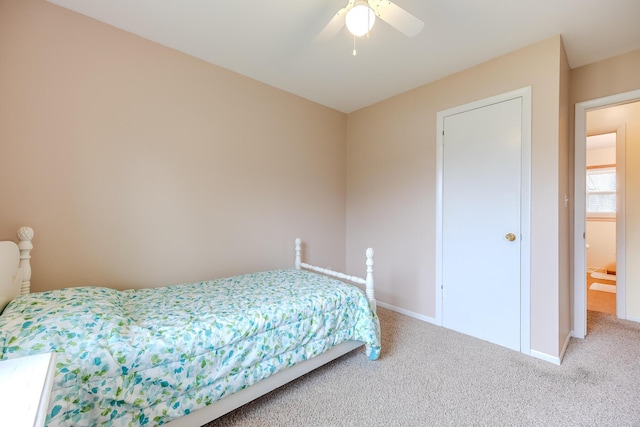 carpeted bedroom featuring a ceiling fan and baseboards