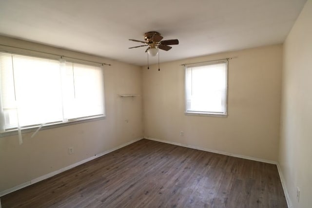 unfurnished room featuring baseboards, wood finished floors, and ceiling fan