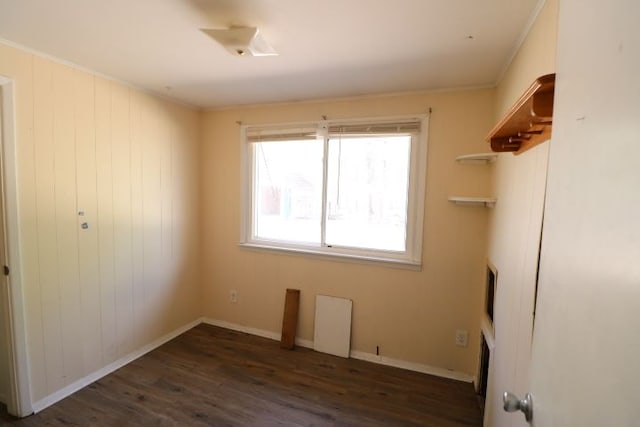 unfurnished bedroom featuring ornamental molding, baseboards, and wood finished floors