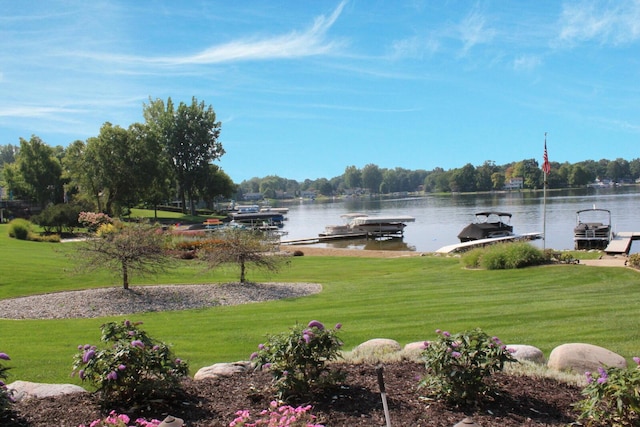 property view of water featuring boat lift and a dock