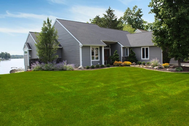 ranch-style home with a water view, a front lawn, and a shingled roof