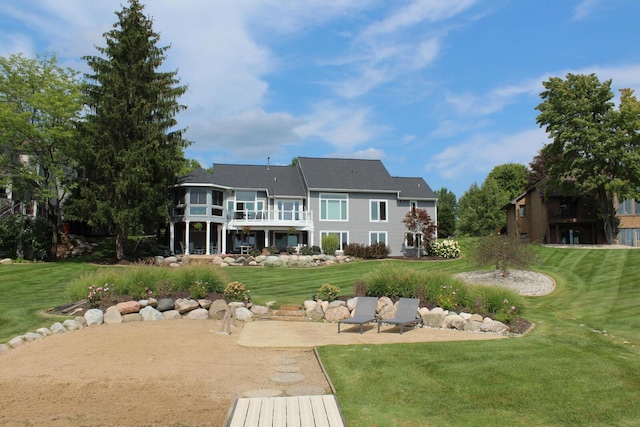 rear view of house with a yard and a patio area