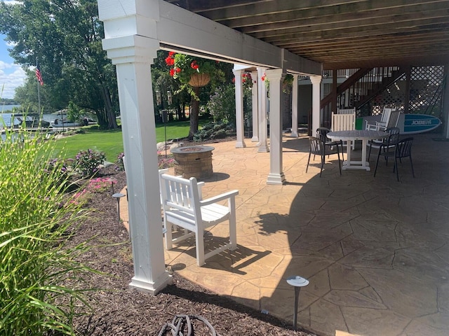 view of patio / terrace featuring an outdoor fire pit and stairs