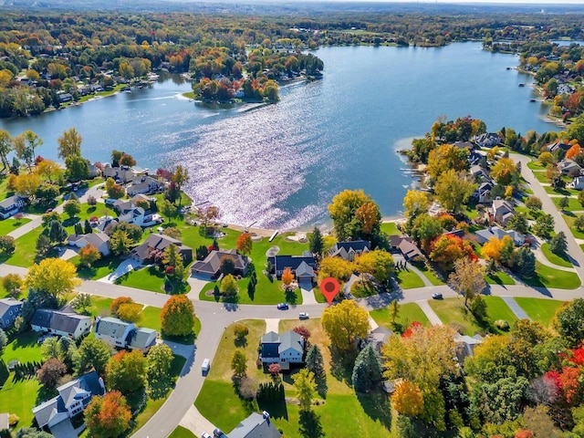 drone / aerial view featuring a residential view and a water view