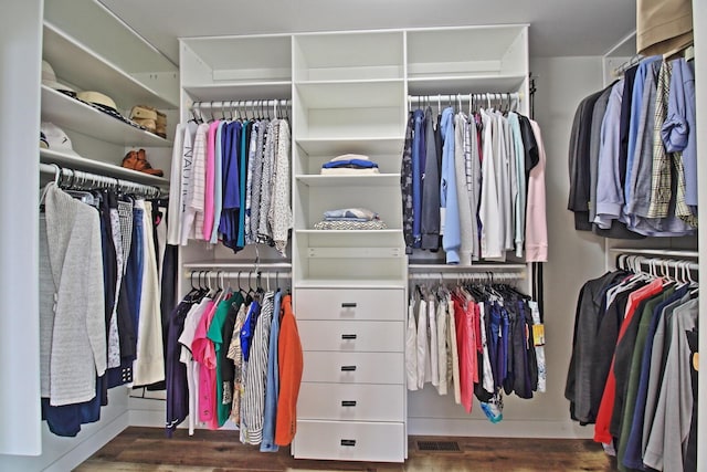 walk in closet with visible vents and wood finished floors