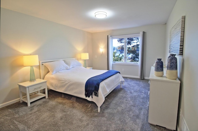 bedroom with visible vents, baseboards, and dark carpet