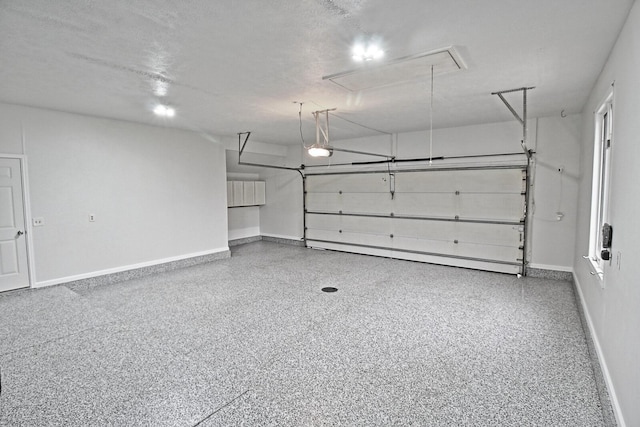 garage with baseboards and a garage door opener