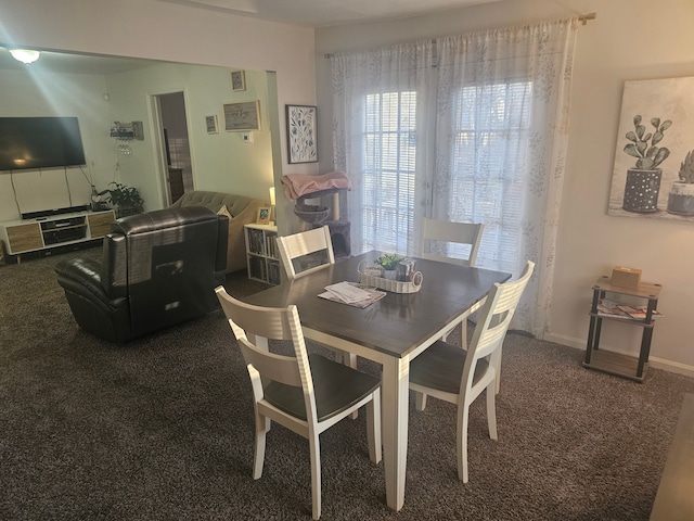 dining area featuring carpet flooring and baseboards