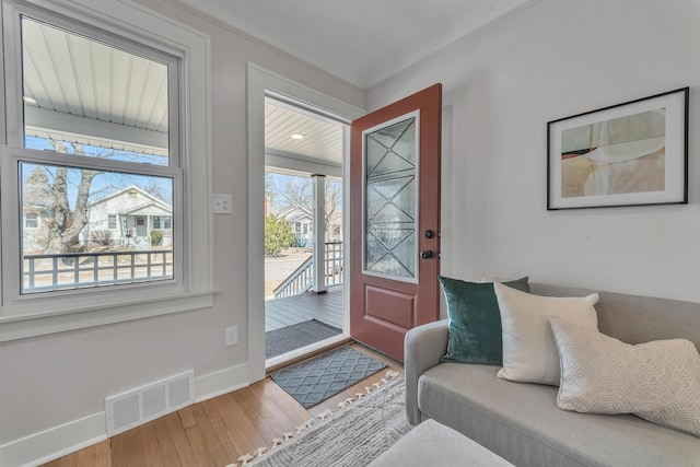 foyer with visible vents, baseboards, and wood finished floors