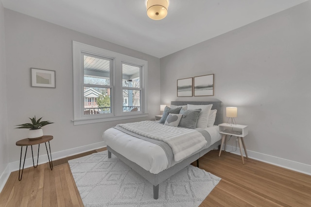 bedroom with light wood-style floors and baseboards