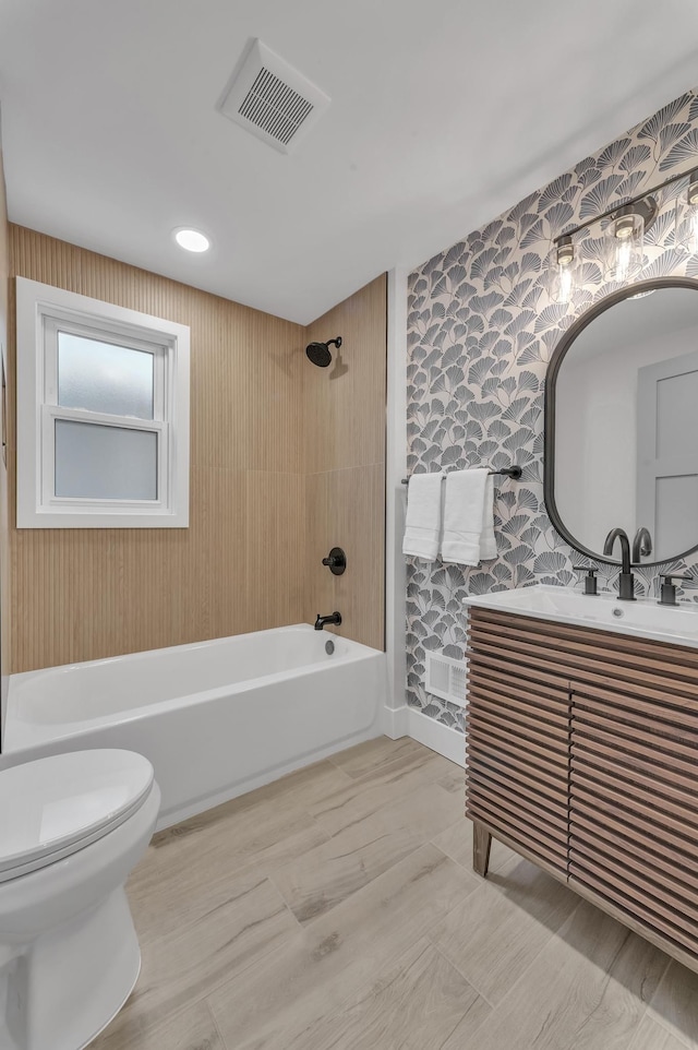 full bathroom with visible vents, tub / shower combination, wallpapered walls, toilet, and vanity