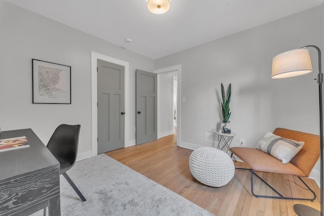 office space with wood finished floors and baseboards