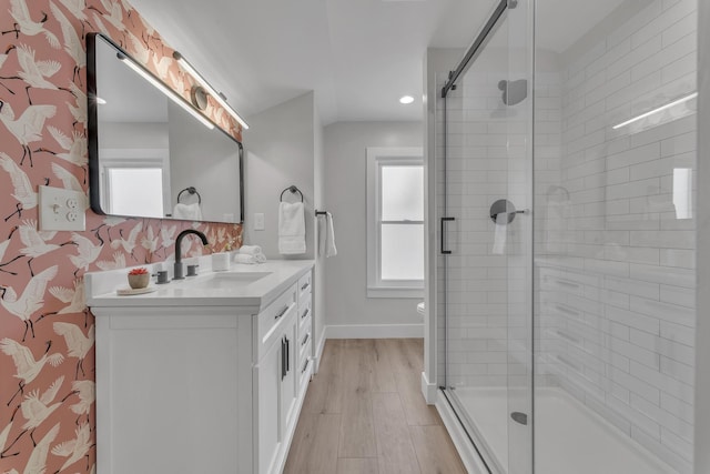 full bathroom with baseboards, vanity, wood finished floors, and a shower stall