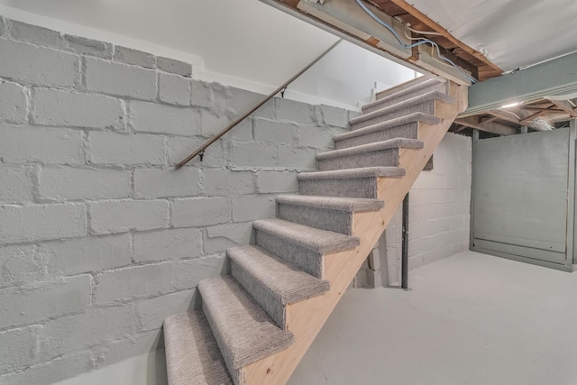 stairway with concrete flooring