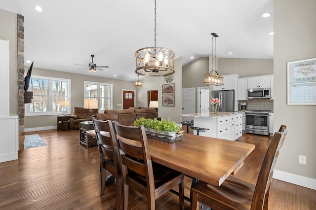 dining area with dark wood-type flooring, recessed lighting, baseboards, and lofted ceiling