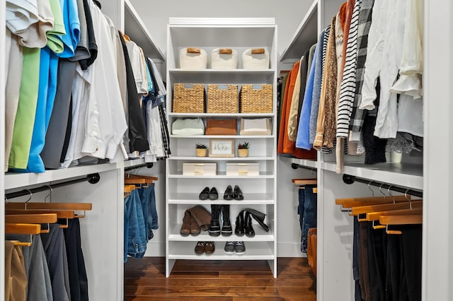 walk in closet with wood finished floors