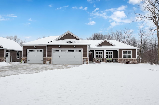 view of front facade with an attached garage and stone siding