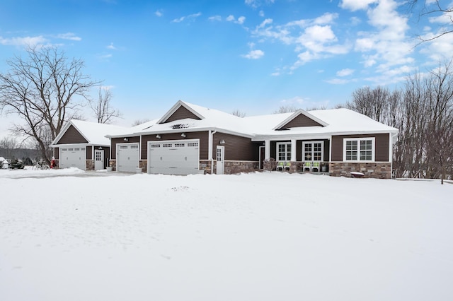 view of front of home featuring an attached garage and stone siding