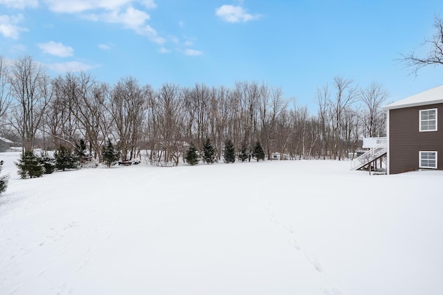 yard layered in snow with stairway