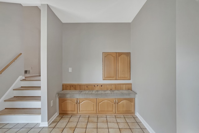 interior space with tile patterned flooring, baseboards, and visible vents