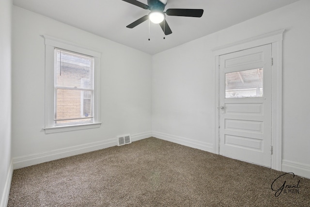 spare room featuring visible vents, baseboards, and carpet