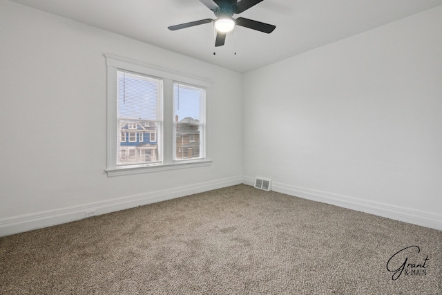 carpeted empty room featuring visible vents, baseboards, and a ceiling fan