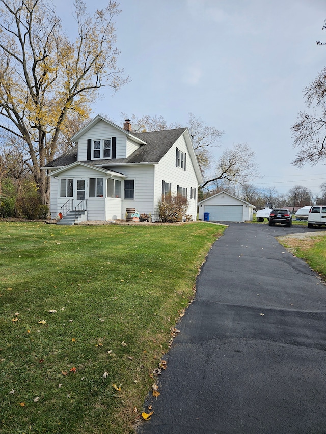 view of front of home featuring entry steps, an outbuilding, a front yard, and a chimney