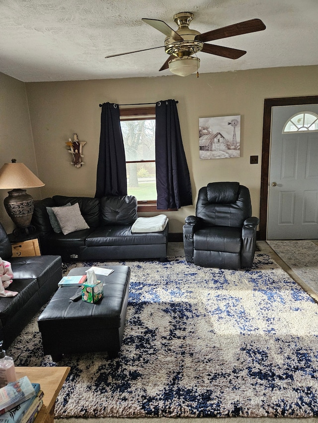 living room featuring a textured ceiling and a ceiling fan