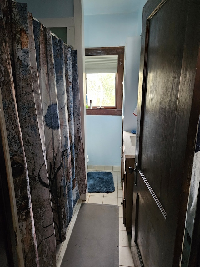 full bath with tile patterned flooring, vanity, and a shower with curtain