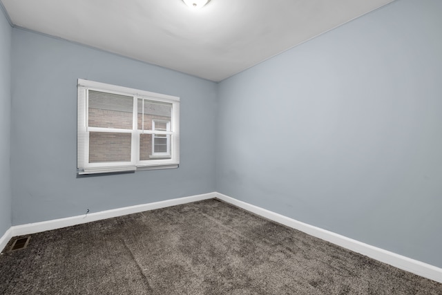 spare room featuring visible vents, baseboards, and carpet flooring