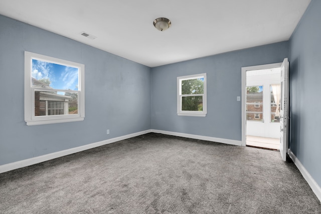 unfurnished room featuring carpet flooring, baseboards, and visible vents