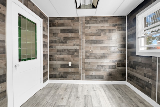 spare room featuring wooden walls and wood finished floors