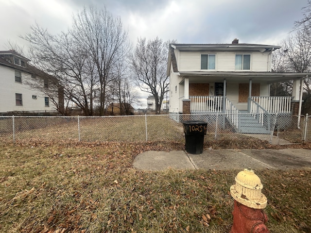 view of front of home featuring a porch and fence private yard